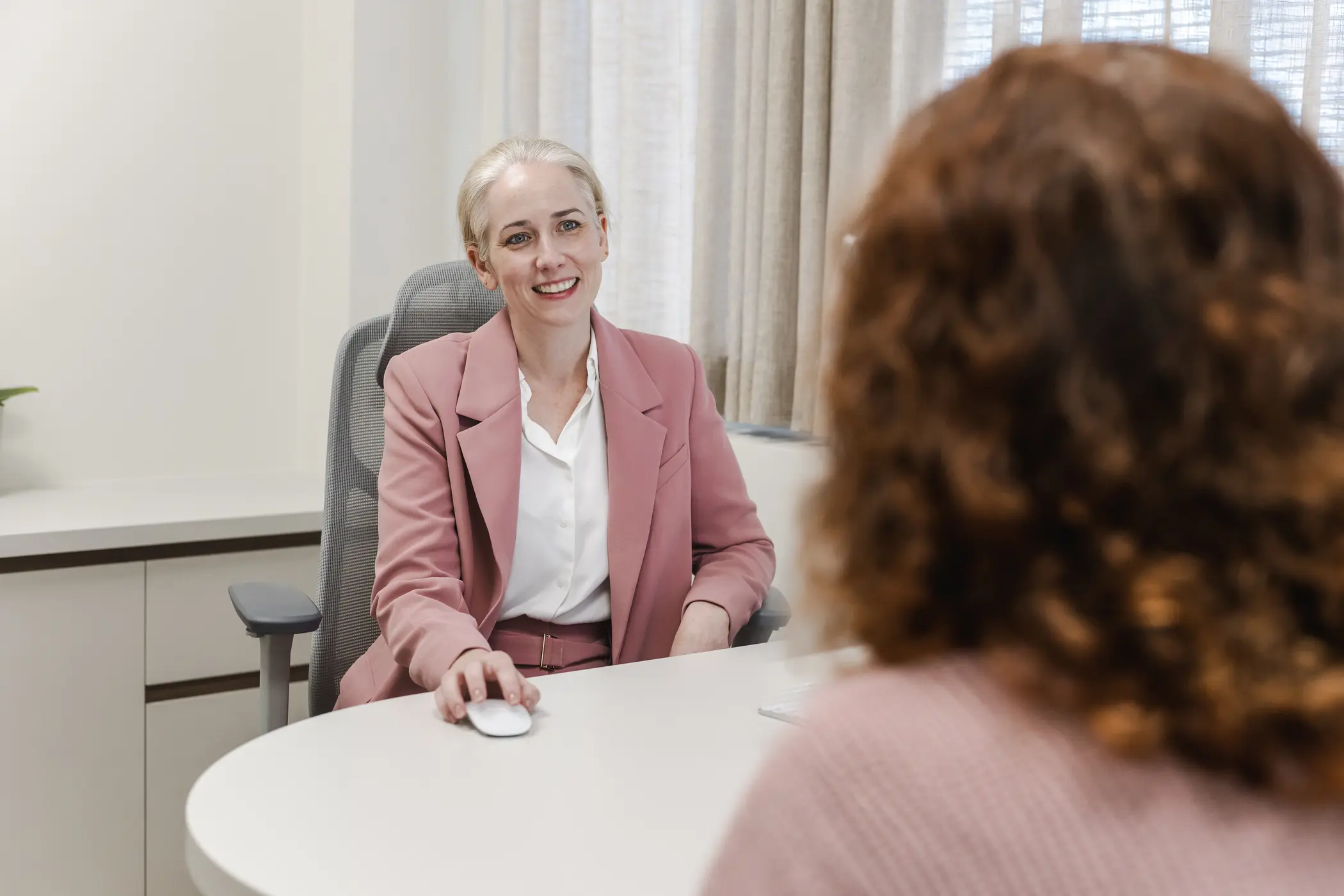 A breast clinician talking with a patient during a consultation