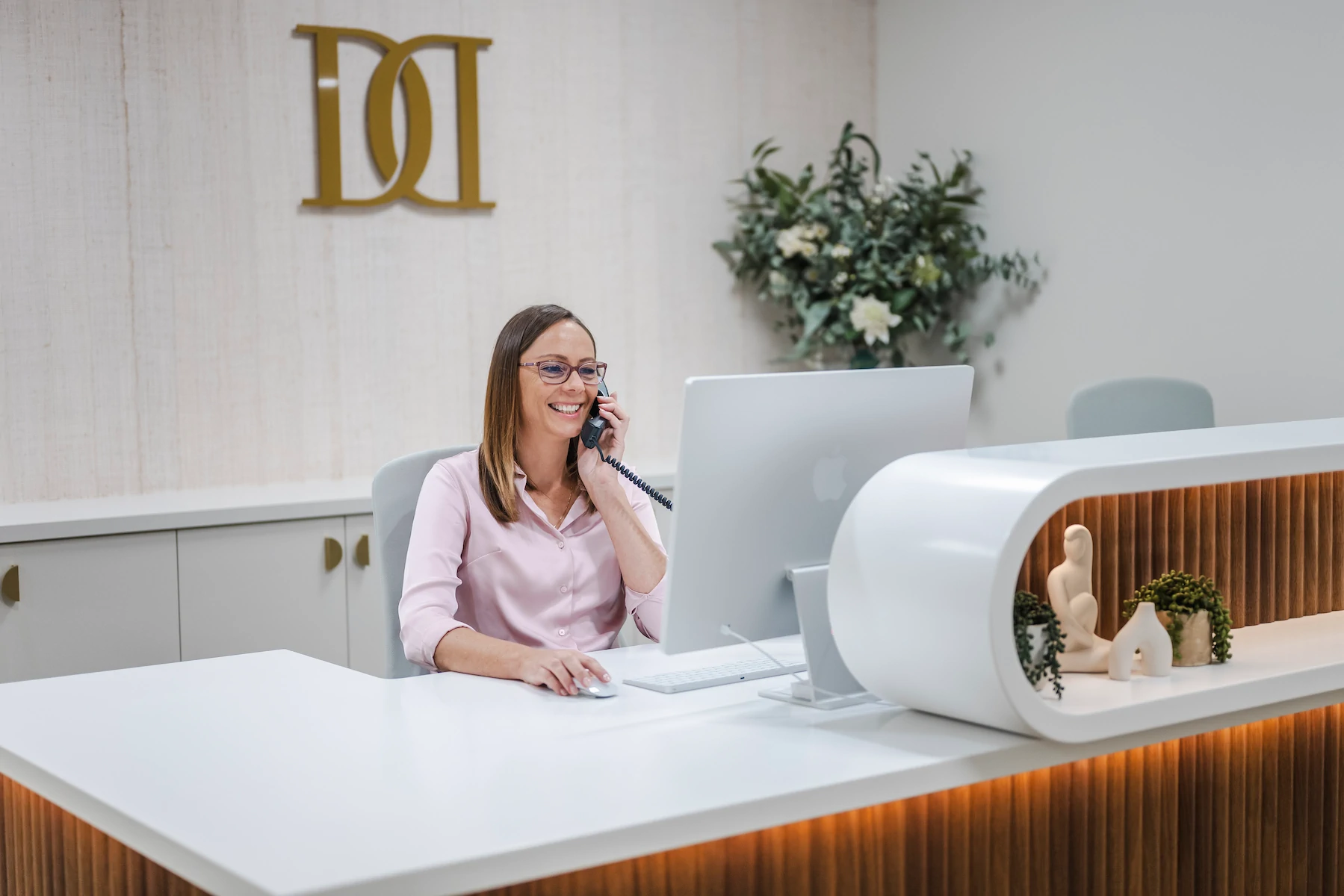 A patient booking an appointment at the clinic reception desk
